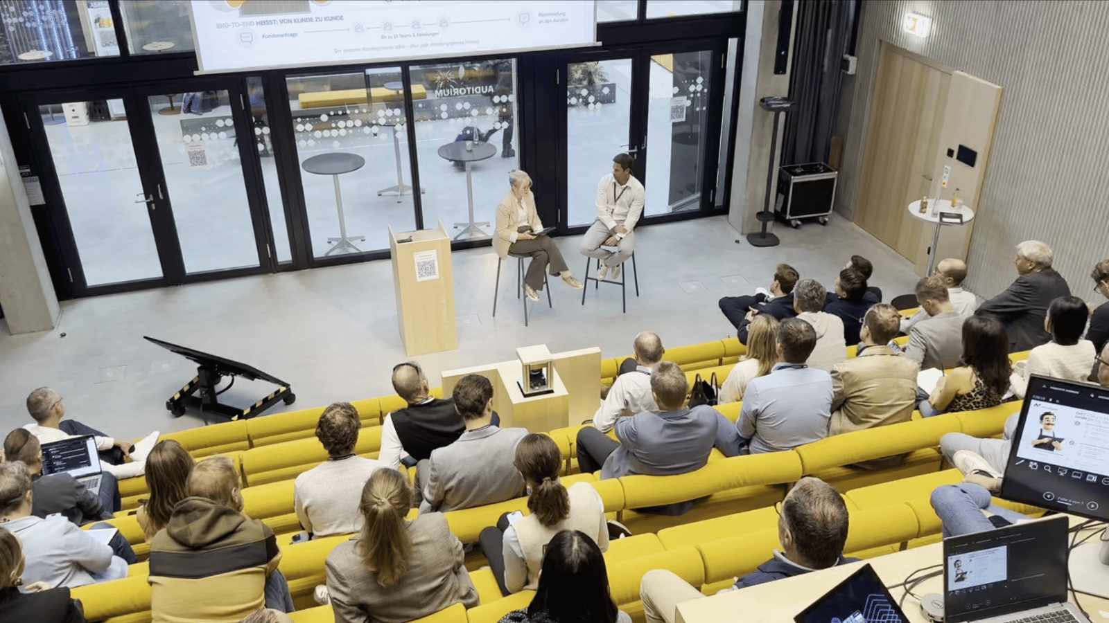 A view of the presentation room from above, with Jana Kiechle in conversation with Herbert Frohner from NovaTaste.